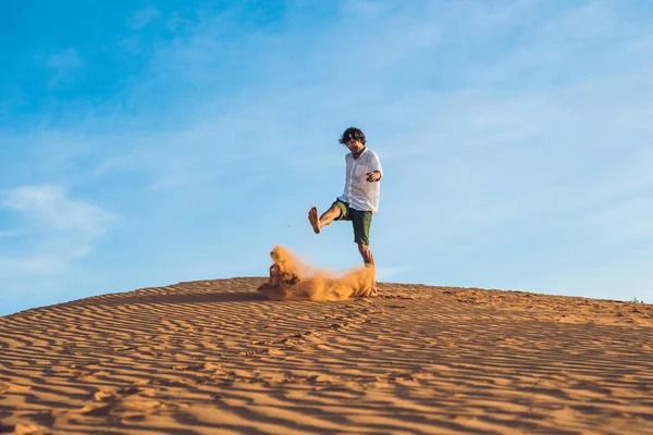 Mann tritt Sand in eine rote Wüste — Stockfoto