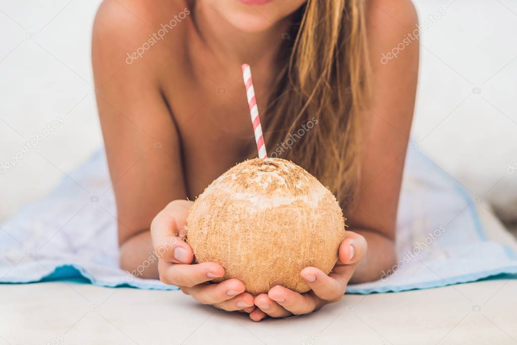 Young woman drinking coconut milk