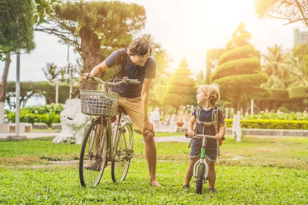 Happy family is riding bikes outdoors