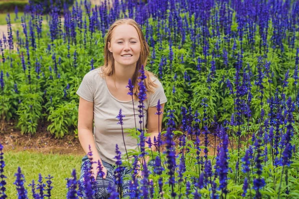 Mulher com flores Salvia farinacea Azul — Fotografia de Stock