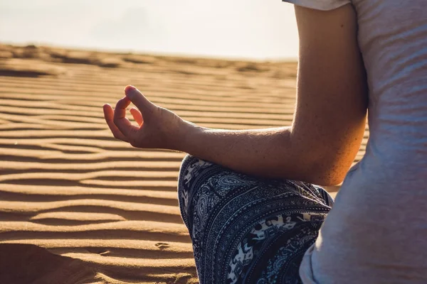 Молодая женщина медитирует в пустыне — стоковое фото