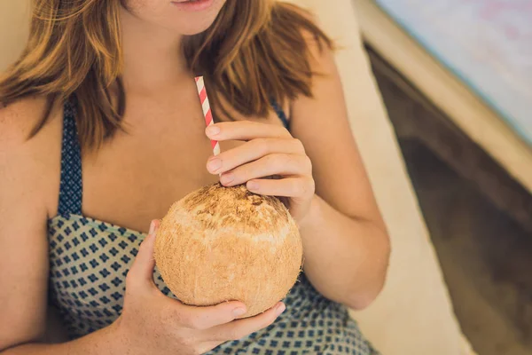 Mujer joven bebiendo leche de coco — Foto de Stock