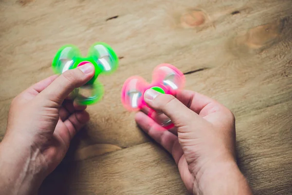 Hands holding hand spinner — Stock Photo, Image