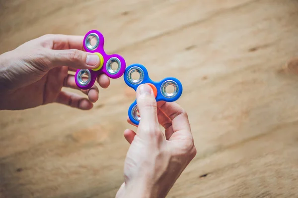 Hands holding hand spinner — Stock Photo, Image