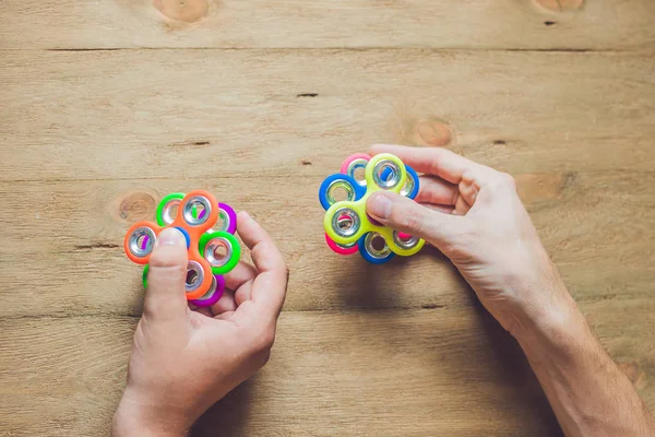 Hands holding hand spinner — Stock Photo, Image