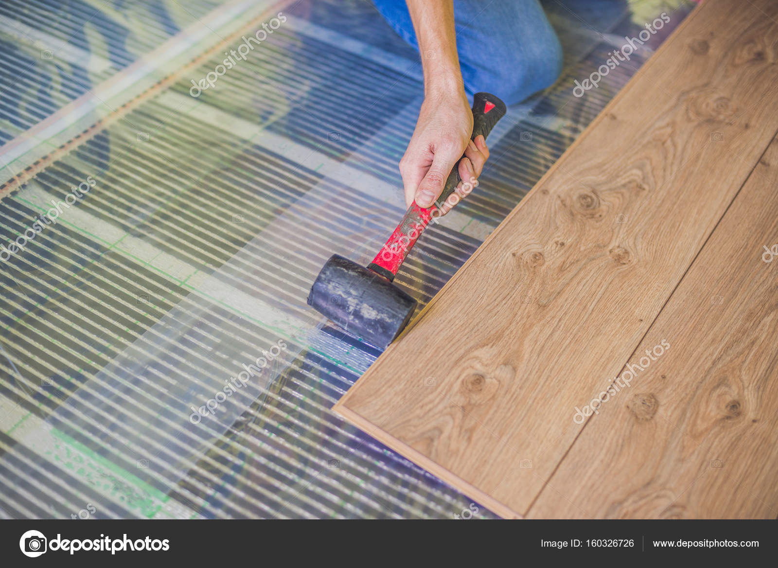 Man Installing New Laminate Flooring Stock Photo Galitskaya Man Installing New Wooden Laminate Flooring On A Warm Floor Infrared Heating System Under Photo By Galitskaya