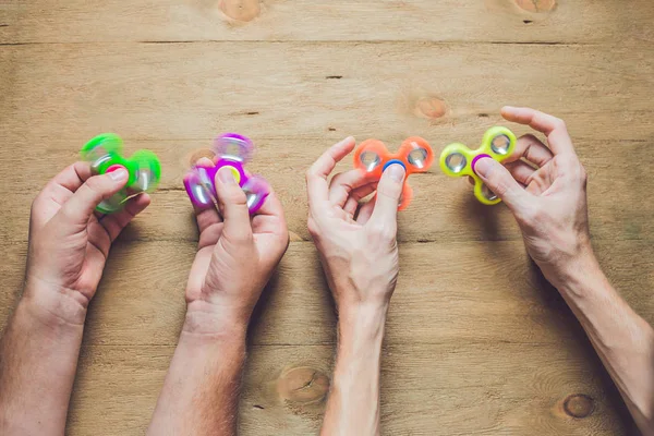 Hands holding hand spinners — Stock Photo, Image