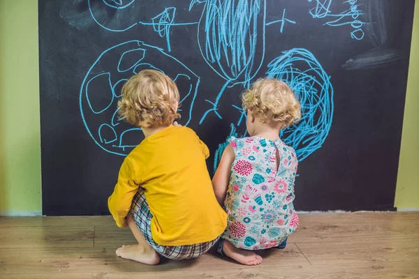 Boy and girl paint with chalk — Stock Photo, Image