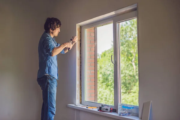 Man in  does window installation — Stock Photo, Image