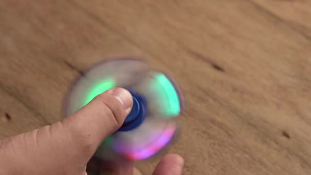 Male hand holding hand spinner — Stock Video