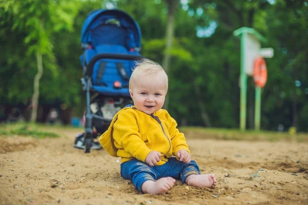 Toddler boy playing with sand — Stock Photo, Image