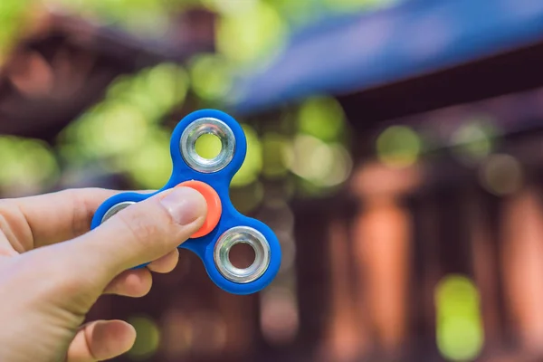 Boy playing with fidget spinner. — Stock Photo, Image