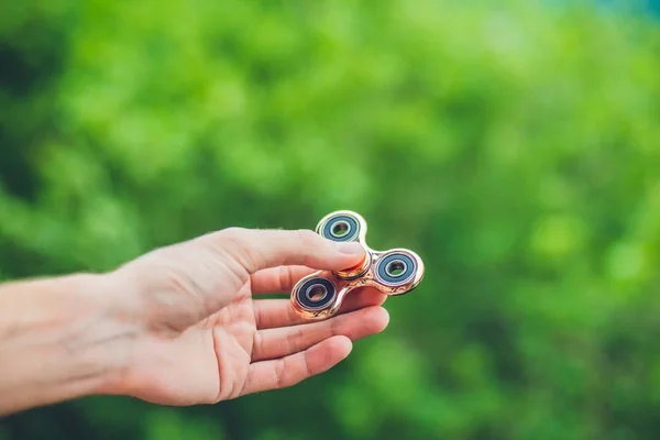 Hand holding a fidget spinner — Stock Photo, Image