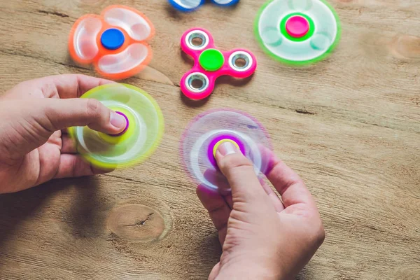 A man hands holding hand spinner — Stock Photo, Image