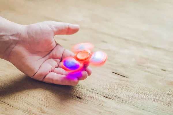 A man hand holding hand spinner — Stock Photo, Image