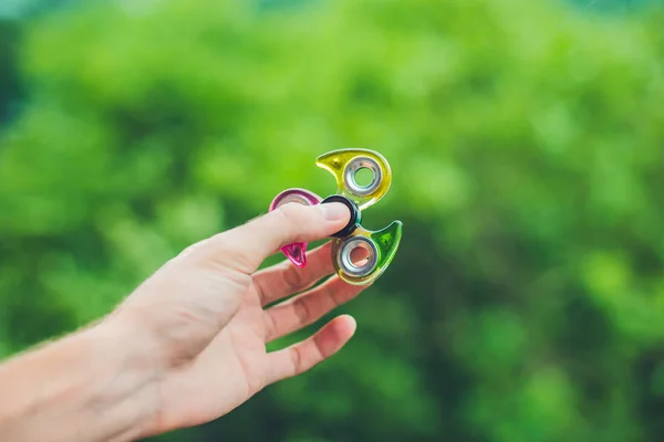 Hand holding a fidget spinner — Stock Photo, Image