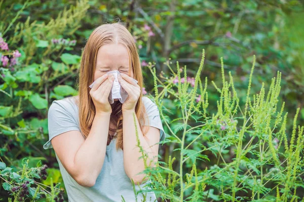 Mujer joven estornuda debido a una alergia — Foto de Stock