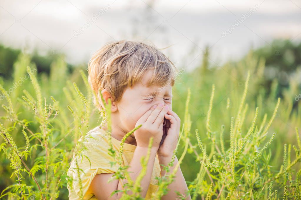 Boy sneezes because of an allergy