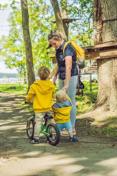 Sarı sweatshirt ve annesi sonbahar parkta iki mutlu kardeşler.