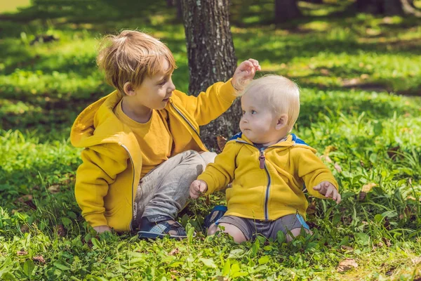 Two happy brothers in yellow sweatshirts