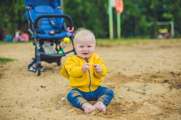 Toddler boy playing with sand — Stock Photo, Image