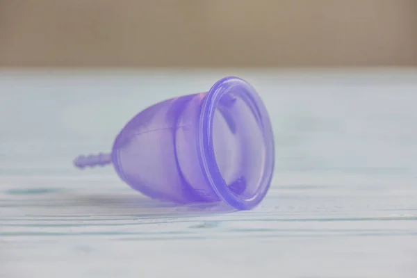 Feminine hygiene product - Menstrual cup On a wooden background — Stock Photo, Image