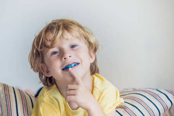 Three-year old boy shows myofunctional trainer to illuminate mouth breathing habit. Helps equalize the growing teeth and correct bite. Corrects the position of the tongue