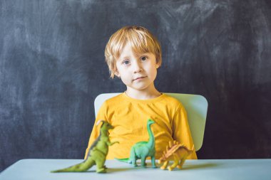 Boy showing dinosaurs clipart