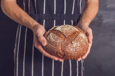Baker man holding homemade bread