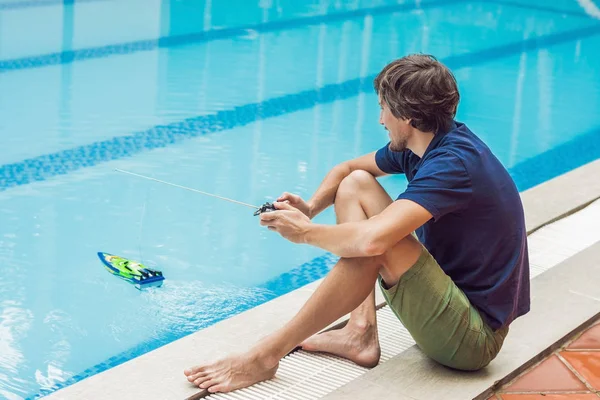 Man playing with remote controlled boat