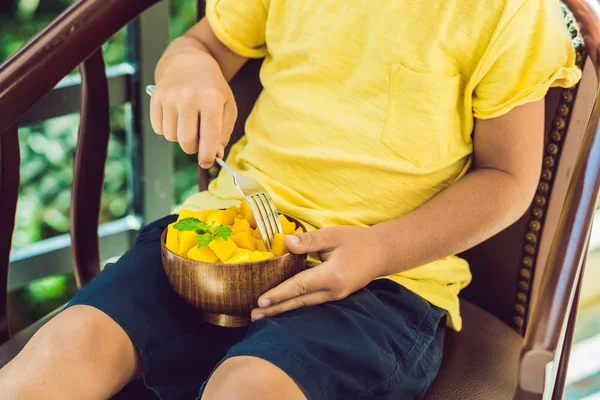 boy eating mango