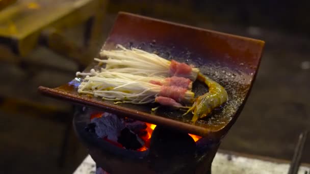 Camarones y champiñones fritos en una parrilla en un café callejero asiático — Vídeo de stock