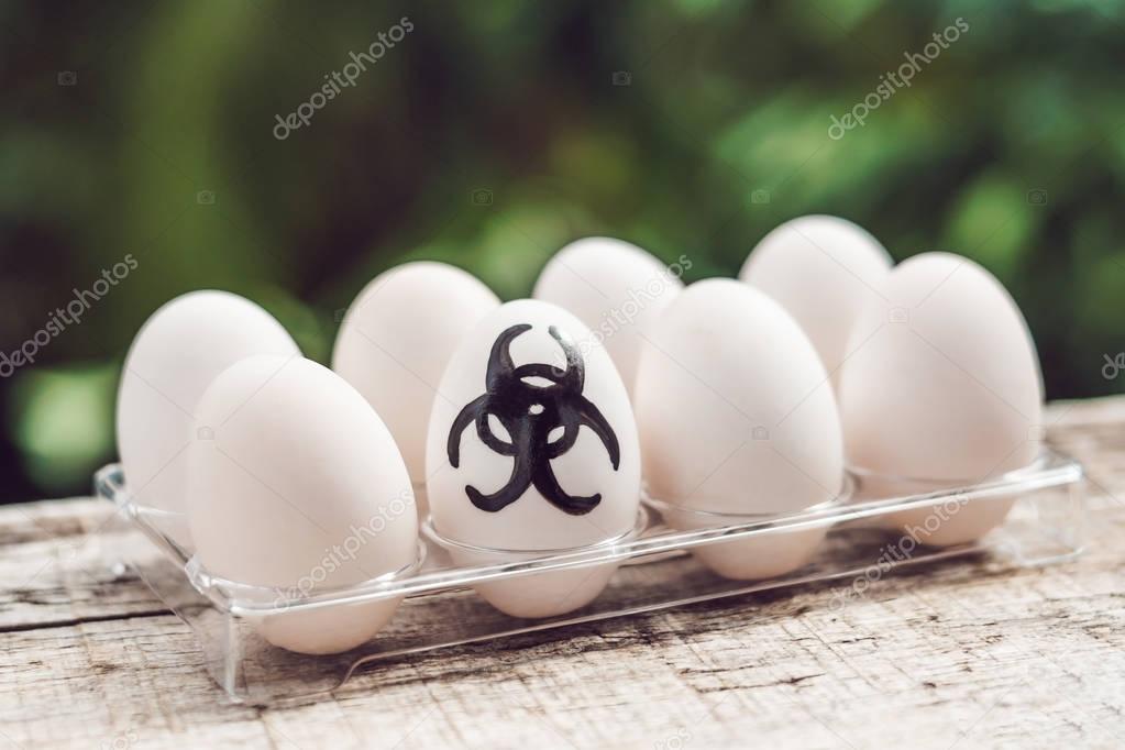 Sign of bio-hazard on the egg. The concept of disease. Avian inf
