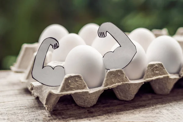 Egg with muscles, concept of egg protein, sports nutrition, diet — Stock Photo, Image