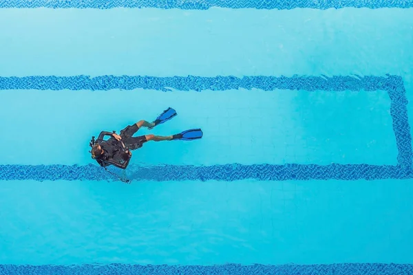 Diving instructor and students. Instructor teaches students to dive.