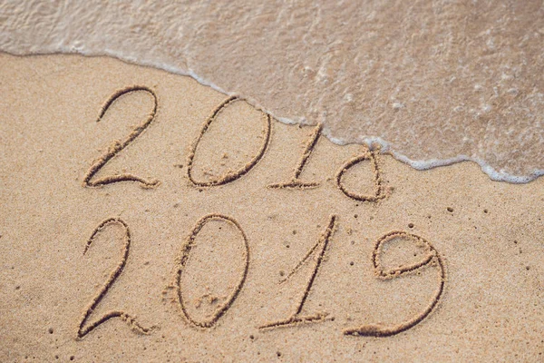 Yeni yıl 2019 önümüzdeki - yazıt 2018 ve 2019 bir plaj kum, dalga neredeyse basamak 2018 kapsayan bir kavramdır.