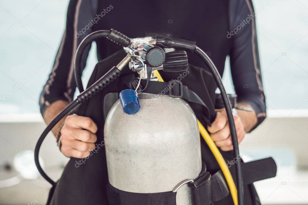 Diver prepares his equipment for diving in the sea.