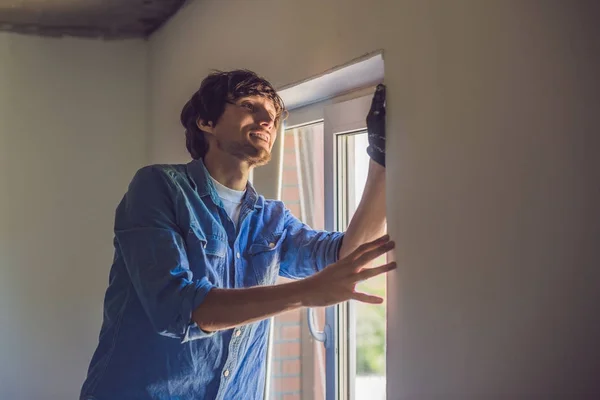 Man in a blue shirt does window installation. — Stock Image Man Blue Shirt Does Window Installation Royalty Free Stock Photos