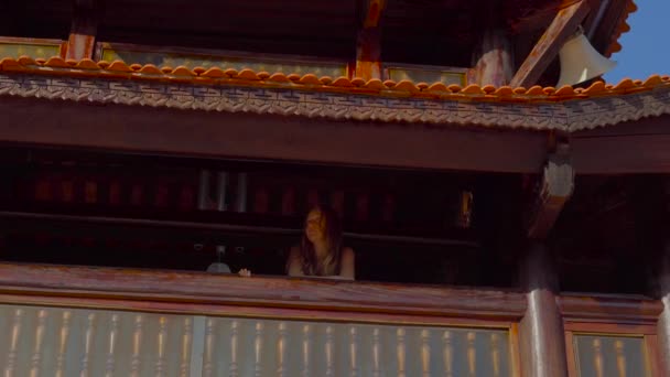 Young woman and her son standing on a second floor inside of a budhist temple Ho Quoc Pagoda on Phu Quoc island, Vietnam — Stock Video