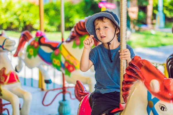 Cute Little Boy Enjoying Funfair Riding Colorful Carousel House — Stock Photo, Image