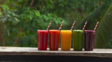 Smoothies gökkuşağı. Smoothies, meyve suları, meyve suyu, içecekler, içecekler çeşitli taze meyve ile ahşap bir masaya.