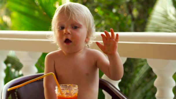 Niño bebiendo y jugando con un batido saludable de frutas y verduras - alimentación saludable, vegetariano, vegetariano, alimentos orgánicos y concepto de bebida . — Vídeos de Stock