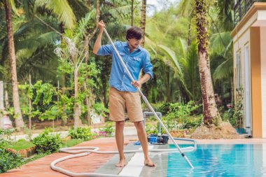 Cleaner of the swimming pool . Man in a blue shirt with cleaning equipment for swimming pools, sunny. clipart
