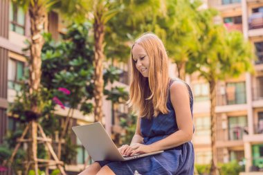Onu laptop ile havuz oturan genç kadın serbest meslek sahibi. Bayramlarda meşgul. Uzak iş kavramı 