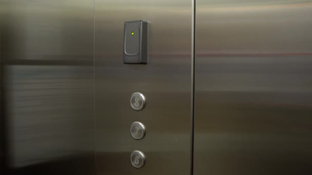 Woman attach his plastic key card in elevator in order to unlock ability to enter his floor — Stock Video