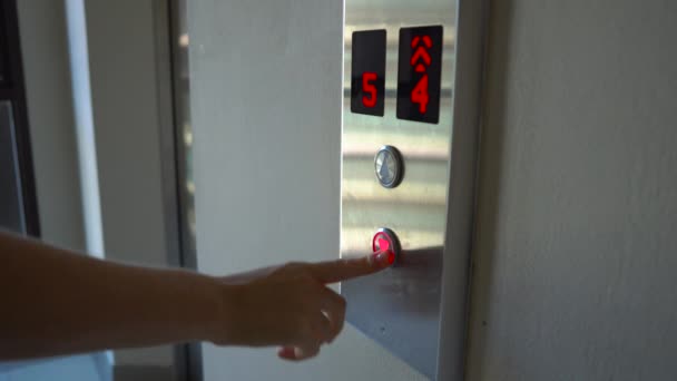 Woman push the button to call an elevator — Stock Video