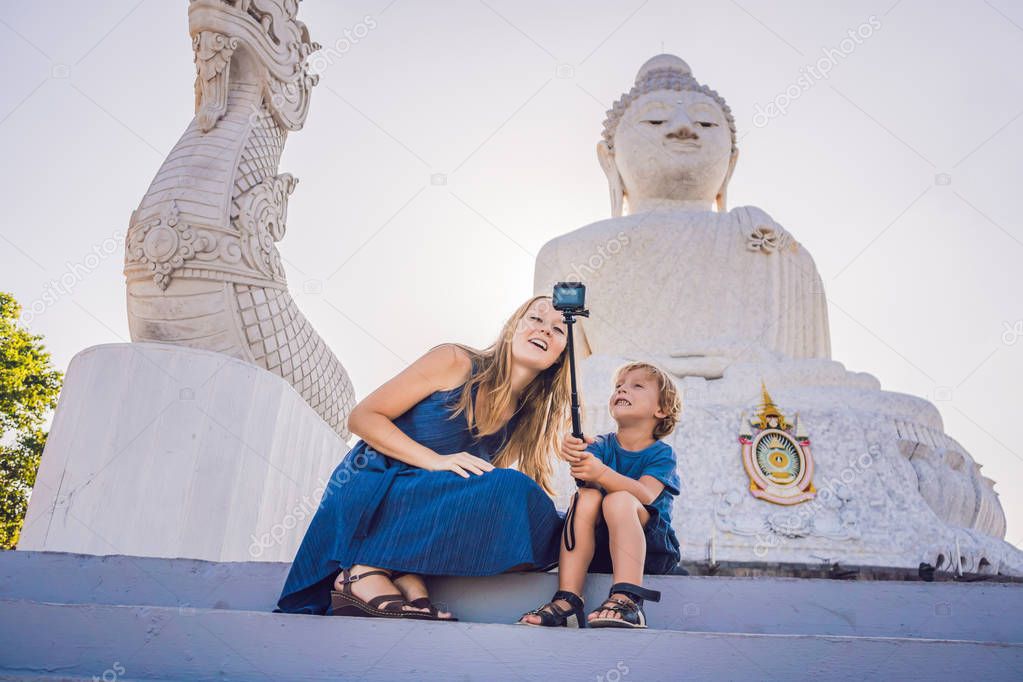 Mother and son tourists on the Big Buddha statue. Was built on a high hilltop of Phuket Thailand Can be seen from a distance