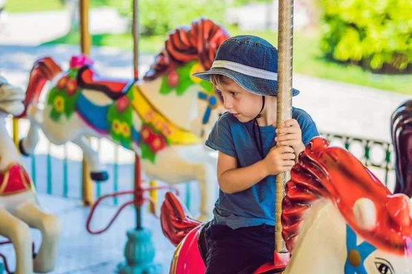 Cute Little Boy Enjoying Funfair Riding Colorful Carousel House — Stock Photo, Image