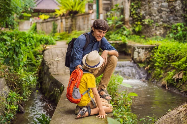 Father and son tourists in Bali walks along the narrow cozy streets of Ubud. Bali is a popular tourist destination. Travel to Bali concept. Traveling with children concept — Stock Photo, Image