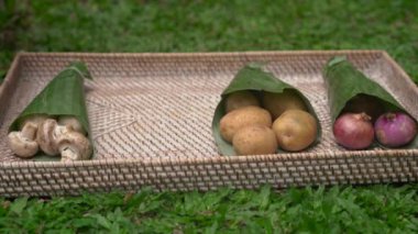 Çevre dostu ürün ambalaj konsepti. Sebzeler bir muz yaprağı sarılmış, plastik bir torba alternatif olarak. Sıfır atık kavramı. Alternatif ambalaj